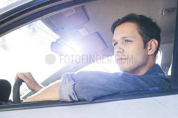 Man enjoying view as he drives car