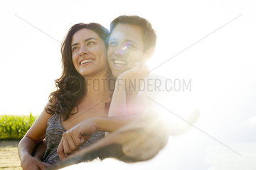 Couple embracing and looking at scenic view