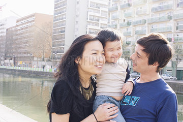 Parents and little boy in city