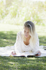 Woman reading magazine in park