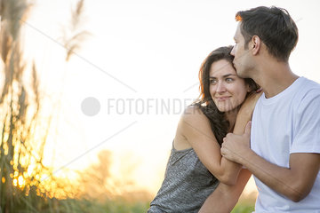 Man kissing girlfriend's forehead