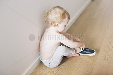 Boy putting on shoes