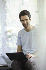 Man using laptop computer at home