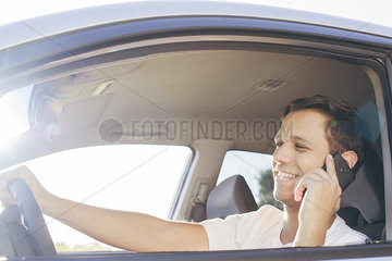 Man chatting on phone while driving