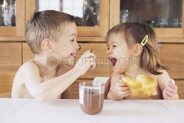 Siblings playing with chocolate spread