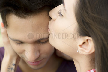 Woman kissing boyfriend's forehead