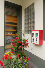 Neuerburg  Deutschland  ein Hauseingang mit Blumen und einem Kaugummiautomat