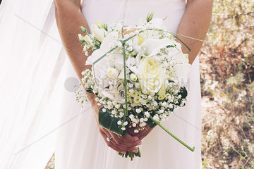 Bride holding bouquet of flowers  cropped