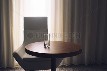 Empty glass on hotel room table