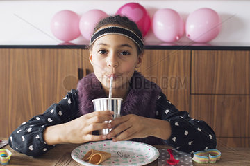 Girl drinking through a straw
