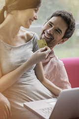 Couple enjoying convenience of online shopping