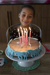 Girl preparing to blow out candles on birthday cake
