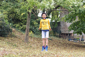 Boy jumping in midair outdoors