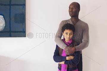 Boy leaning against father  portrait