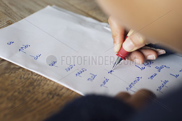Child writing in cursive on paper  cropped