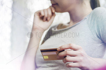 Woman holding credit card  cropped