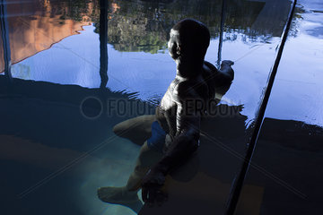 Man relaxing in indoor pool