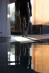 Man walking away from indoor pool  cropped