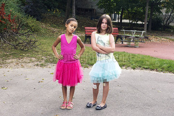 Girls dressed in tutus with tough expression on faces