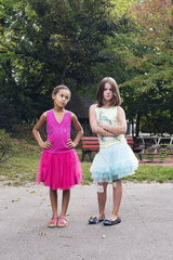 Girls dressed in tutus with tough expression on faces