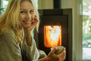 Mature woman relaxing with coffee at home  portrait