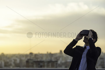 Man using virtual reality headset outdoors