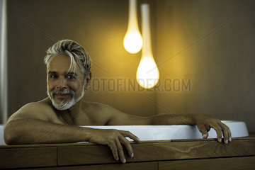 Man soaking in hot tub