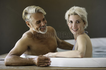 Couple soaking in spa