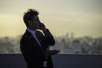 Man talking on mobile phone outdoors