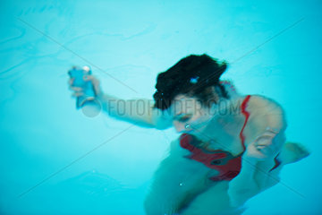 Woman relaxing underwater in swimming pool