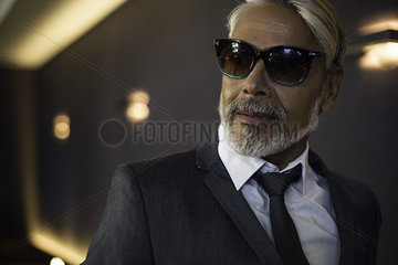 Man wearing suit and sunglasses