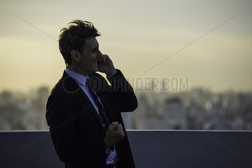 Man talking on mobile phone outdoors