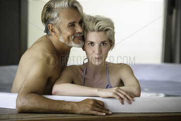 Couple soaking in spa