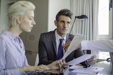 Man and woman reviewing document being explained to them