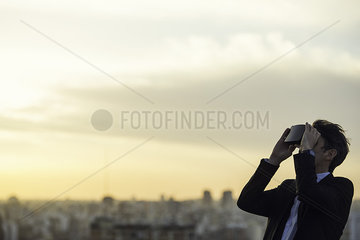 Man using virtual reality headset outdoors