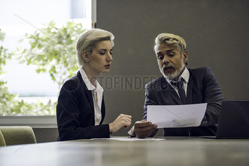 Woman and man in office discussing document