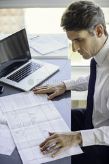 Man working with blueprints
