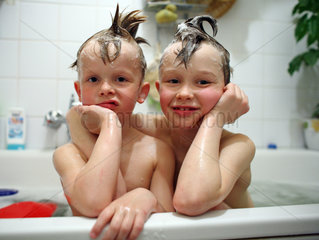 Kinder albern in der Badewanne herum