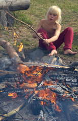 Beeskow  Deutschland  ein Junge am Lagerfeuer im Feriencamp Brandenburg-Safari