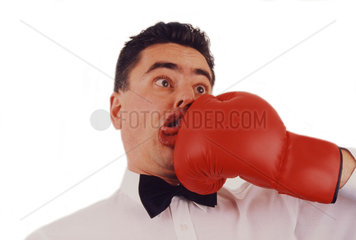 Man being punched with a boxing glove