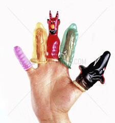 Five colorful condoms on a man's hand