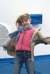 Olbia  Kind stemmt sich gegen den Wind auf einer Faehre