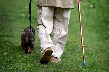 Berlin  Deutschland  ein aelterer Mann geht mit seinem Hund Gassi