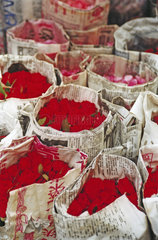bunches of roses wrapped in newspapers