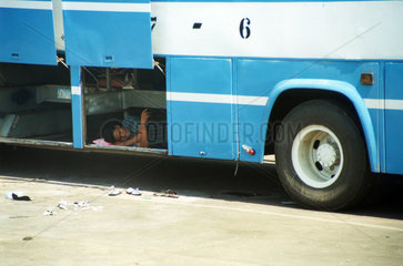 man sleeping in a bus