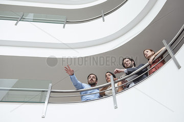 Businessman pointing while talking with his colleagues