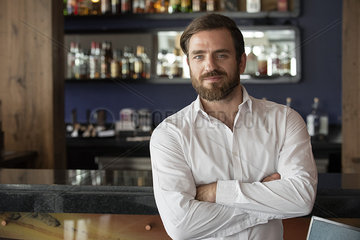 Mid adult man standing in bar