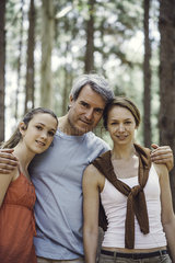 Portrait of family standing in forest