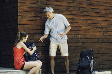 Father and daughter packing bag