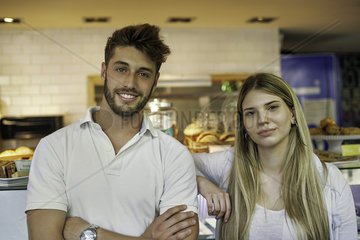 Couple standing in cake shop